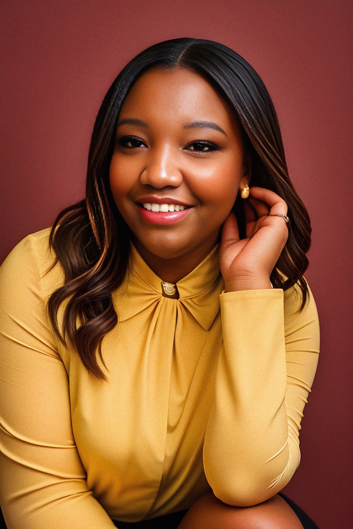 Domonique Downing in editorial portrait, smiling against a neutral backdrop